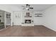Bright living room featuring a stone fireplace and modern ceiling fan at 1822 W Rose Ln, Phoenix, AZ 85015