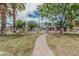 Pathway to community pool, surrounded by palm trees and lush landscaping at 1822 W Rose Ln, Phoenix, AZ 85015