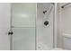 Bathroom shower with glass doors, tile surround, and black hardware. Fixtures are modern and clean at 1822 W Rose Ln, Phoenix, AZ 85015