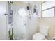 Modern bathroom featuring white tiled walls, stylish shower, and decorative hanging plants at 18843 N 45Th Ave, Glendale, AZ 85308