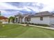 Well-maintained home exterior with green lawn, putting green, and lush landscaping at 18843 N 45Th Ave, Glendale, AZ 85308