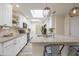 Well-lit kitchen with white cabinets, granite countertops, and a central island at 18843 N 45Th Ave, Glendale, AZ 85308