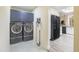 Updated laundry room features slate-colored washer/dryer, overhead storage, and easy access to the adjacent kitchen area at 18843 N 45Th Ave, Glendale, AZ 85308