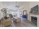 Spacious living room featuring a fireplace, vaulted ceilings, and an open layout at 18843 N 45Th Ave, Glendale, AZ 85308