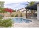 Inviting backyard pool featuring colorful landscaping and a covered patio at 18843 N 45Th Ave, Glendale, AZ 85308