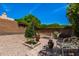 Backyard landscape with decorative flowers, shrubbery, and pavers under blue sky at 198 N Nevada Way, Gilbert, AZ 85233