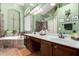 Elegant bathroom features double sinks, garden tub, shower, and modern fixtures at 198 N Nevada Way, Gilbert, AZ 85233