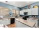 Bright kitchen boasts white cabinets, granite countertops, and updated appliances at 198 N Nevada Way, Gilbert, AZ 85233