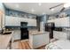 Well-lit kitchen with white cabinets, granite countertops, and modern appliances, offering style and functionality at 198 N Nevada Way, Gilbert, AZ 85233
