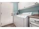 Bright laundry area has washer, dryer, cabinets, and a door to outside at 198 N Nevada Way, Gilbert, AZ 85233