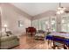 Bright living room boasts large windows with plantation shutters, a piano, and comfortable seating, ideal for relaxation at 198 N Nevada Way, Gilbert, AZ 85233