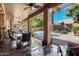 Covered outdoor patio offers a great view of the backyard pool and desert landscape at 198 N Nevada Way, Gilbert, AZ 85233