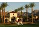 Welcoming entryway with lush landscaping, a water feature, and views of the mountains at 20638 W Berridge Ln, Buckeye, AZ 85396