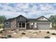 Charming single-story home featuring stone accents, modern architecture, and a two-car garage at 20638 W Berridge Ln, Buckeye, AZ 85396