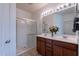 Bathroom with walk-in shower, double sink vanity, and large mirror at 21277 E Cherrywood Dr, Queen Creek, AZ 85142