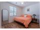 Bedroom featuring a window, wood-look floors, and large mirror at 21277 E Cherrywood Dr, Queen Creek, AZ 85142