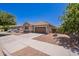 Street view of a well-maintained, one-story home with a two-car garage and desert landscaping on a sunny day at 21277 E Cherrywood Dr, Queen Creek, AZ 85142