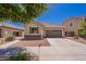Charming single-story home featuring a two-car garage, desert landscaping, and a welcoming facade on a sunny day at 21277 E Cherrywood Dr, Queen Creek, AZ 85142