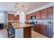 Gourmet kitchen featuring granite countertops, ample cabinet space, and modern stainless steel appliances at 21277 E Cherrywood Dr, Queen Creek, AZ 85142