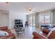 Bright living area featuring tile floors, comfortable leather furniture, and sliding glass doors to the patio at 21277 E Cherrywood Dr, Queen Creek, AZ 85142