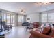 Spacious living room with tile flooring, ceiling fans, and large windows offering abundant natural light at 21277 E Cherrywood Dr, Queen Creek, AZ 85142