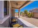 Covered patio with plenty of seating overlooking the landscaped backyard at 21277 E Cherrywood Dr, Queen Creek, AZ 85142