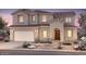 Beautiful two-story home featuring a neutral color scheme, manicured landscaping and a two car garage at 22450 E San Tan Blvd, Queen Creek, AZ 85142