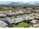 Aerial view of a home with a pool and lush green lawn in a neighborhood with mountain views at 22842 E Via Las Brisas --, Queen Creek, AZ 85142