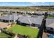 Aerial view of a home with a large green lawn backyard and a covered patio, perfect for outdoor living at 22842 E Via Las Brisas --, Queen Creek, AZ 85142