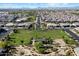 Wide aerial view of a neighborhood with a green common area and park surrounded by homes at 22842 E Via Las Brisas --, Queen Creek, AZ 85142