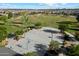 Aerial view of a basketball court within a community park, featuring mature trees and families enjoying outdoor activities at 22842 E Via Las Brisas --, Queen Creek, AZ 85142
