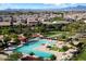Resort-style community pool featuring palm trees, lounge chairs, and shaded seating areas at 22842 E Via Las Brisas --, Queen Creek, AZ 85142