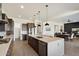 Open kitchen layout with a large island, stainless appliances, and seamless flow to the dining area at 22842 E Via Las Brisas --, Queen Creek, AZ 85142