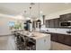 Bright kitchen with island seating, sleek appliances, and modern pendant lighting at 22842 E Via Las Brisas --, Queen Creek, AZ 85142