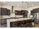 Modern kitchen with a large center island, stainless steel appliances, and dark wood cabinets at 22842 E Via Las Brisas --, Queen Creek, AZ 85142