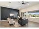 Spacious living room boasts a black accent wall, stylish furniture, and plenty of natural light from large windows at 22842 E Via Las Brisas --, Queen Creek, AZ 85142