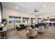 Bright living room features stylish furniture, wood floors, and large windows with a view of the backyard at 22842 E Via Las Brisas --, Queen Creek, AZ 85142