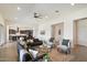 Open-concept living room showcases contemporary furniture, a ceiling fan, and seamless flow into the kitchen at 22842 E Via Las Brisas --, Queen Creek, AZ 85142