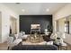 Comfortable living room boasts modern decor, a large black accent wall, and an open floor plan at 22842 E Via Las Brisas --, Queen Creek, AZ 85142