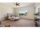 Comfortable main bedroom features soft carpet, a ceiling fan, and a backyard view at 22842 E Via Las Brisas --, Queen Creek, AZ 85142