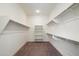 Large walk-in closet with shelving and neutral carpet at 22842 E Via Las Brisas --, Queen Creek, AZ 85142