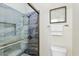 Stylish bathroom features a glass-enclosed shower with attractive blue stone-style tile and built-in shelf at 2402 E 5Th St # 1741, Tempe, AZ 85288