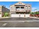Attractive exterior of a multi-story home with multiple garage doors, a front balcony and a clean yard at 2402 E 5Th St # 1741, Tempe, AZ 85288