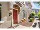 Charming home exterior showcasing a red front door with decorative stone facade and manicured landscaping at 2402 E 5Th St # 1741, Tempe, AZ 85288