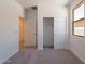 Bedroom featuring neutral walls, carpet, a window view, and a closet at 24184 W Gibson Ln, Buckeye, AZ 85326
