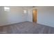 Spacious bedroom with carpeted floors and access to a bathroom with a glass-enclosed shower at 24184 W Gibson Ln, Buckeye, AZ 85326