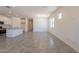Spacious living area that showcases an open layout, tile floors, and a seamless connection to the modern kitchen at 24184 W Gibson Ln, Buckeye, AZ 85326