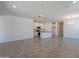 Bright and airy living space with tile flooring, recessed lighting, and an open layout leading into a modern kitchen at 24184 W Gibson Ln, Buckeye, AZ 85326