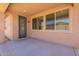 Covered patio area featuring a doorway and set of windows offering outdoor living and natural light at 24184 W Gibson Ln, Buckeye, AZ 85326