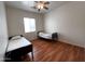 Bedroom features twin beds, hardwood floors, and natural light from the window at 2427 W Desert Hills Estate Dr, Phoenix, AZ 85086